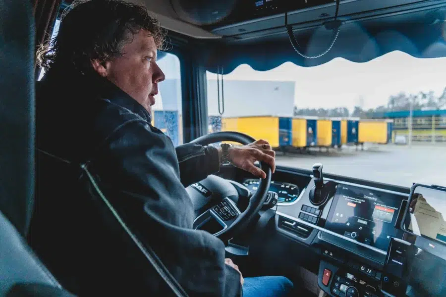 A driver drives off a fleet of trucks. You watch from the bed and see how he steers, where he looks and the yellow trailers left on the fleet.